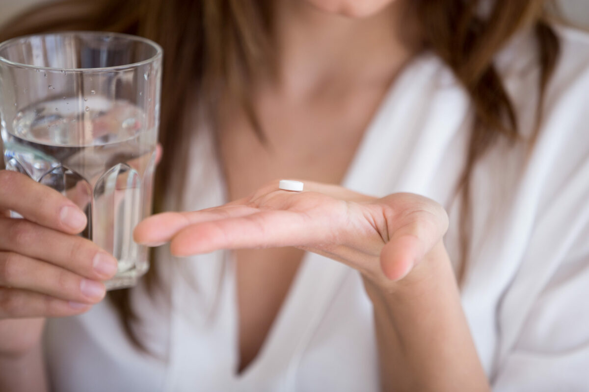 Woman,Holding,Pill,And,Glass,Of,Water,In,Hands,Taking